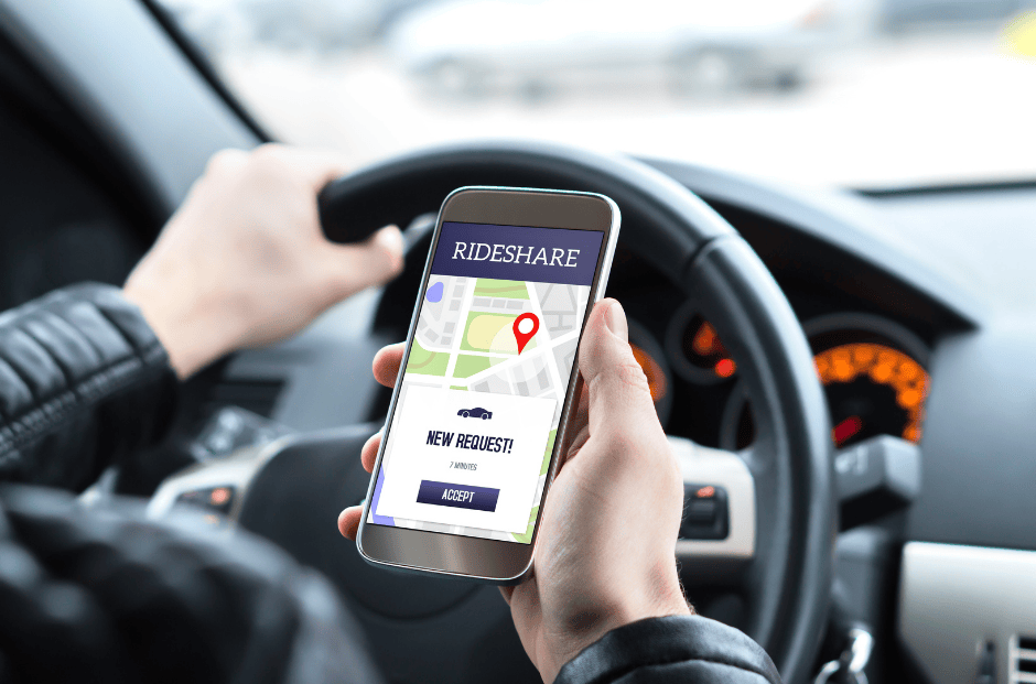 Phone being held up in front of a steering wheel