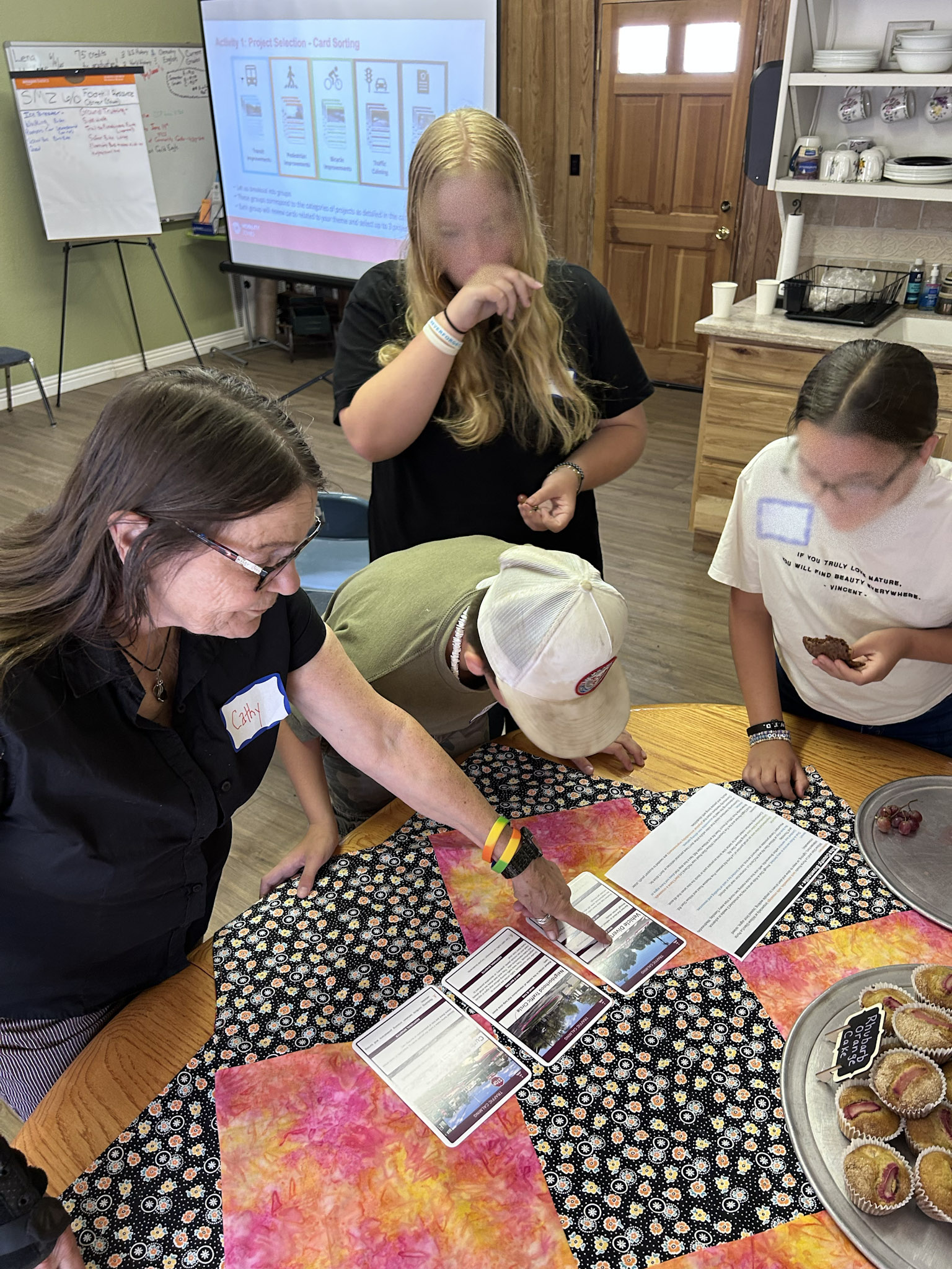 Group of people focused over a document on a table.