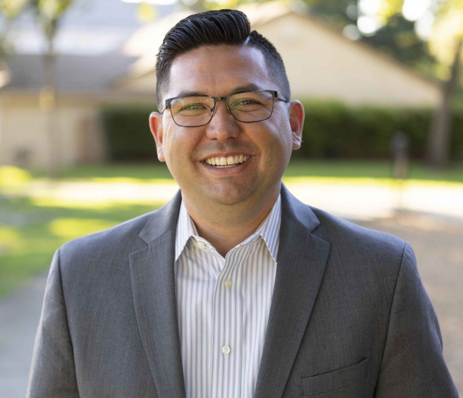 Headshot of Josh Hoover standing in front of a house outside