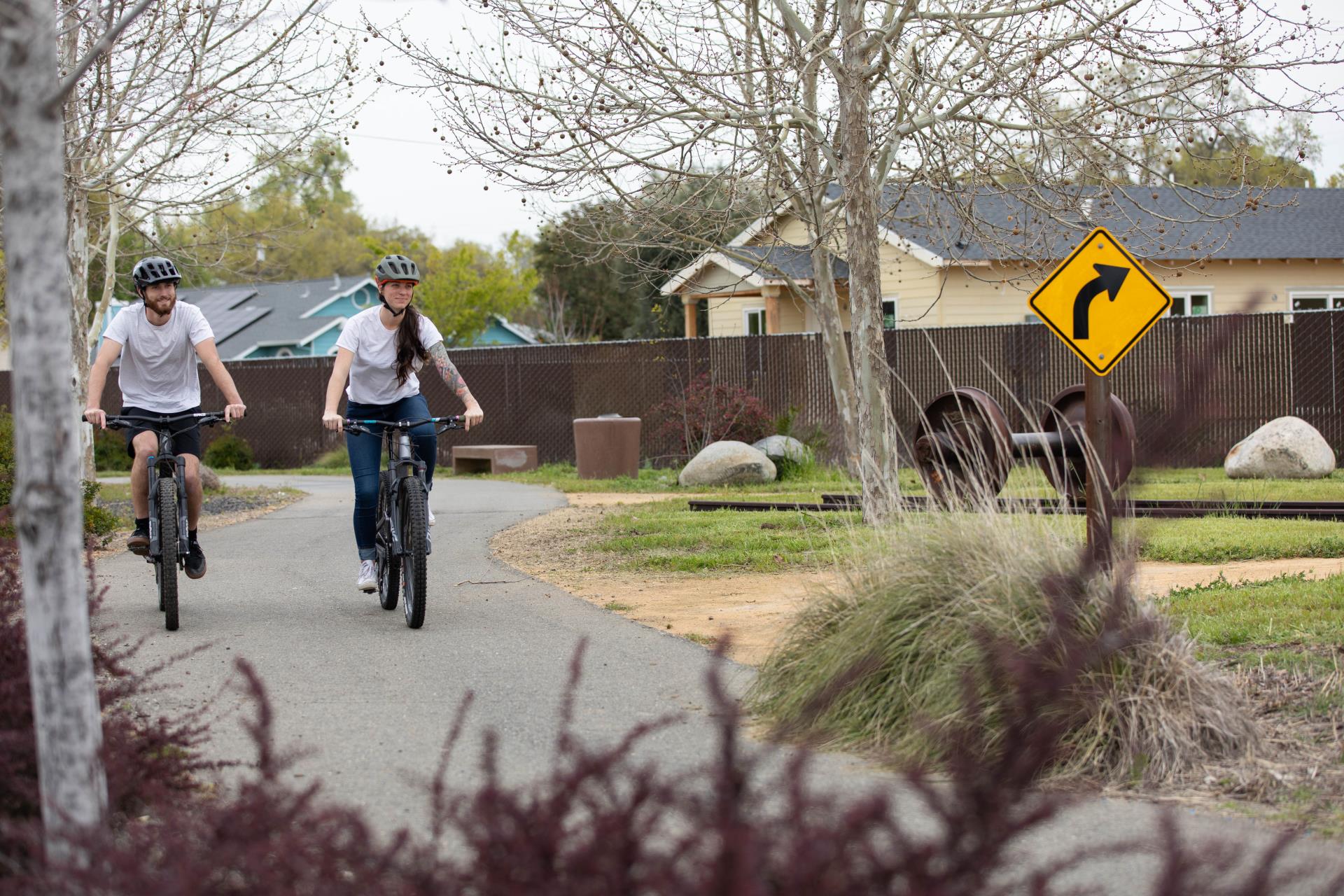 Man and woman riding bikes on bike trail